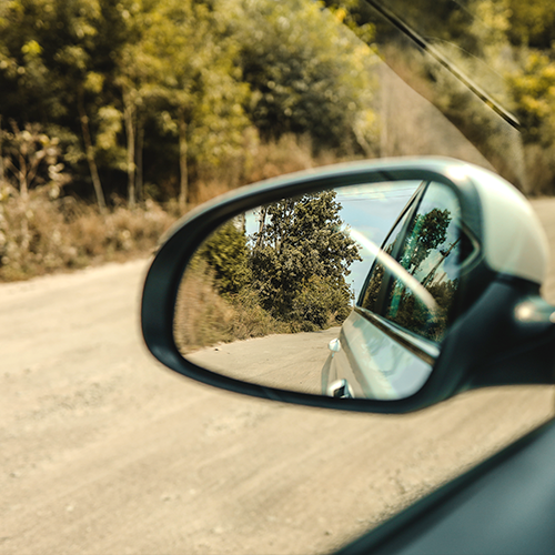 Side mirror reflecting rural road